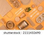 Small photo of Eco-friendly tableware - kraft paper food packaging on yellow or orange background. Street food paper packaging, recyclable paperware, zero waste packaging concept. Flat lay, mockup image