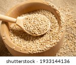 white sesame seeds, sesame seeds in a wooden spoon on an old rustic background close-up