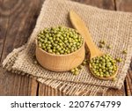 Close-up mung beans .Green mung beans in a wooden bowl on an old table