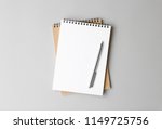 top view of a open notebook with pen on a gray background, school notebooks with a spiral spring, office notepad flat lay
