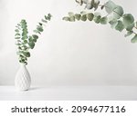 Small photo of spring eucaliptus green branches in white vase. mockup for product placement or motivating incription. light and airy mock up. minimal scandinavian nordic style design