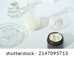 Small photo of laboratory dishes and glassware on a lab table. fermentation, fermented beauty skin care. container with cream or solution or serum for anti age treatment, powder cosmetic ingredient