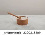Small photo of Xanthan Gum Powder in wooden bowl with spoon. Food additive E415. Texture improver. Stabiliser and Thickener. Used in cosmetic, and food industry as binding agent.