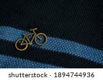 Golden Bicycle Pin On A Dark...