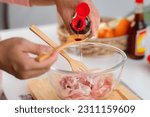 Step-by-step procedures to marinate pork for easy Korean cooking, add chopped onions and Japanese bunching onion, sesame oil, soy sauce, Korean gochujang and mix well. Korean homemade food for lunch