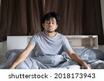 Small photo of young asian man feebleness after waking up