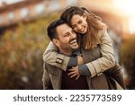 Loving young couple hugging and smiling together outdoors.