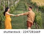 Couple holding hands and dance in vineyard. Couple enjoying  in a vineyard.