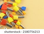 Small photo of Coloured crimp terminals for different wire sizes. Copper sleeves for crimping electrical cables. Ferrules. Selective focus, copy space