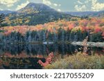 Small photo of Autumn scene in Kinsman Notch, New Hampshire. Mount Moosilauke with reflection of colorful fall foliage on calm surface of Beaver Pond in White Mountain National Forest.