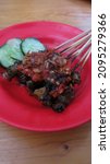 Small photo of Sate Kakul or sate keong, Balinese snail satay. Served with red hot spicy chili sauce