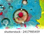 Small photo of A drawing created by several paints diluted in a liquid with the addition of bubbles.