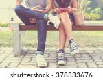 Close up of hipster couple in disinterest moment with smart phones in the outdoor, concept of relationship apathy and isolating using new technology and smartphone addiction