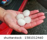 Four large pieces of hail in the hand