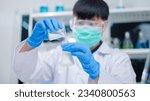 Small photo of Nutritionist or scientist is pouring and holding a bottle of sample milk. Concept of nutrition, lactose, protein, bacteria, fat and glucose laboratory. Dairy milk test, research or analysis product.