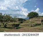 Small photo of Closer look at banquette with platforms of Circle 4 of Guachimontones circular pyramid ruins with green grass and blue sky. One of the Teuchitlan Culture sites within the Tequila Valleys.