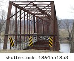 Old framework of bridge.  Rusty brown framework of an old bridge over the Des Moines River.