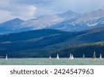 Small photo of Silverthorne, Colorado, USA - August 12 2022. Boats sailing on Lake Dillon I Colorado. Blue sky, blue choppy water with whitecaps on windblown water. Waves and sailboats with mountain backdrops.