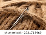 The eye of a needle for sewing with thread close-up. Needle with twine