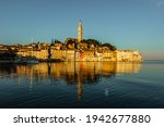 Rovinj,Istria,Croatia.View of the town situated on the coast of Adriatic Sea.Popular tourist resort and fishing port.Old town at sunrise with cobblestone streets, colorful houses and the church tower 