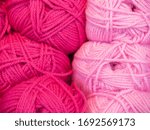 Small photo of Pink balls of wool textile material thread, string, rope for knit and krochet handmade crat as abstract textured background.