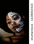 Small photo of a head shot of a dark face painted model, Benedicta from Nigeria 2020