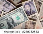 Small photo of Accumulation of Japanese Yen banknotes and dollars. 10,000 Japanese yen, 5,000 Japanese yen, 5 dollars, and 1 dollar.