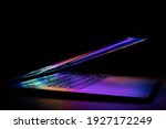 a laptop half closed bright and glowing
