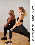 Small photo of sporty differents women do fitness exercises together isolated in studio, slim and cubby mixed race women in sportswear