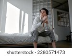 Small photo of young unhappy exhausted man sitting at home, close up side view portrait , blameless life, guy makes decission.copy space