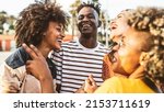 Small photo of Young happy people laughing together - Multiracial friends group having fun on city street - Diverse culture students portrait celebrating outside - Friendship, community, youth, university concept.