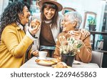 Small photo of Three senior women enjoying breakfast drinking coffee at bar cafeteria - Life style concept with mature female having fun hanging out on city street