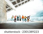 Small photo of Happy group of young people jumping on city street - Multiracial students college celebrating outside - Life style concept with guys and girls having fun together hanging outside