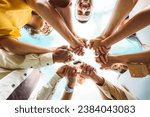 Small photo of Multi ethnic group of young people holding hands outdoors - Community life style concept with guys and girls hugging together outside - Unity, support and collaboration concept