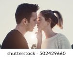 Loving couple kissing outdoor at sunset - Concept about people, love and lifestyle