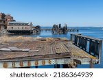 Small photo of View along the waterfront of downtown Port Townsend Historic District, WA, USA, with mostly dilapidated remains of historic buildings and non-operational old ferry pier