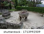 Small photo of Samosir Island, North Sumatra/Indonesia - 04.14.13: Stone chairs of Ambarita huta with the execution stone of the Batak people who held court here and who practiced cannibalism until the 1800's
