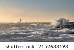 Small photo of Lighthouse in windy sea with high waves