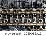 Disassembled powerful V12 engine of passenger car without cylinders head cover close-up in engine oil lubrication