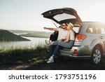 Man and Woman Relaxing Inside Car Trunk Enjoying Weekend Road Trip, Travel and Adventure Concept