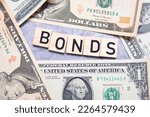 The inscription bonds next to American dollars. Concept showing investing in government debt securities
