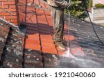 State of roof before and after washing with high pressure. Professional is wearing uniform and using equipment for cleaning.