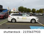 Small photo of Melbourne, Australia - 12th May 2022: Prepolling at an election polling booth in Cranbourne, a car has been decorated to promote The United Australia Party run by Clive Palmer