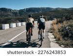Small photo of Two cyclists training on Vall d'Ebo pass.Cycling in the spanish mountains.Cyclists in helmets and cycling wear conquer Vall d'Ebo pass.Sport motivation.Cycling professional group ride.Beautiful view.