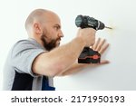 Professional Handyman Using A...