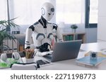 Small photo of A humanoid robot works in an office on a laptop, showcasing the utility of automation in repetitive and tedious tasks.