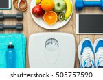 Sports and workout equipment, digital tablet and fruit on a wooden table, training and healthy lifestyle concept, flat lay