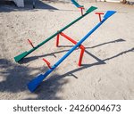 Small photo of Two seesaws in a playground for children's toys. A green seesaw and a blue one