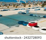 Small photo of Temporary go-kart track in a supermarket parking lot. Blue and white tires to demarcate the track