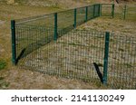 Small photo of fence with a bottom which is made of collapsed panels as protection against game. the fence cannot be undercut. now the house and garden are protected, a low-protection dog training ground